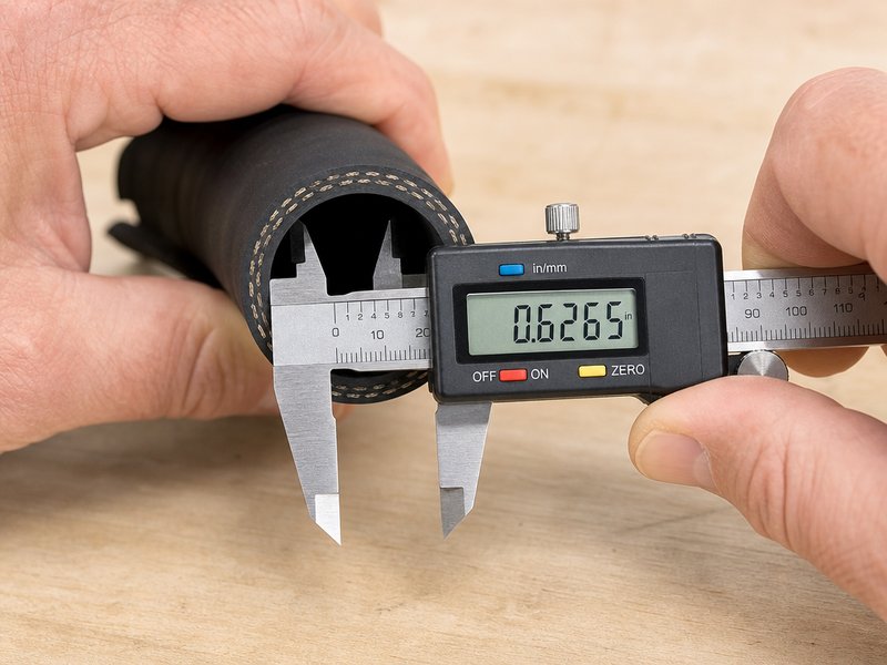 Measuring the inside diameter of an air hose with a digital caliper to confirm the air hose size