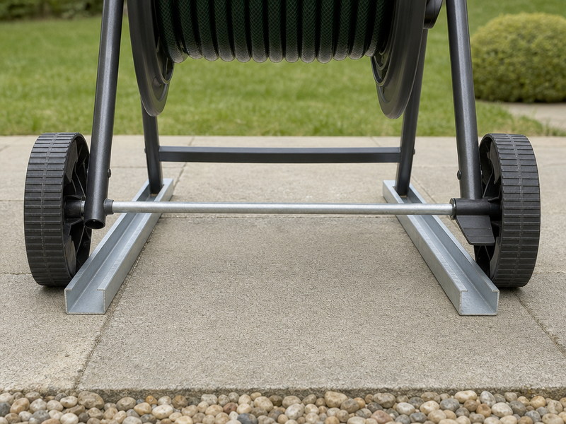 Wheeled hose reel base: wide footprint, two wheels on a metal axle and the brake engaged