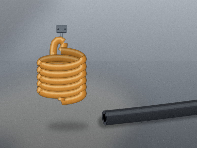 A coiled polyurethane air hose hanging beside a straight rubber air hose on a workshop floor