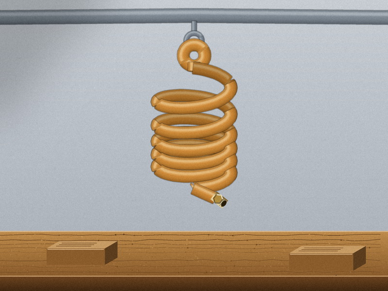 Coiled polyurethane air hose mounted overhead on a workshop bench, retracted and clear of the work area